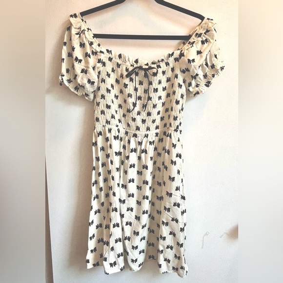 Monteau Dresses & Skirts - Cream Ruffled Off-Shoulder Dress with Black Bow Design